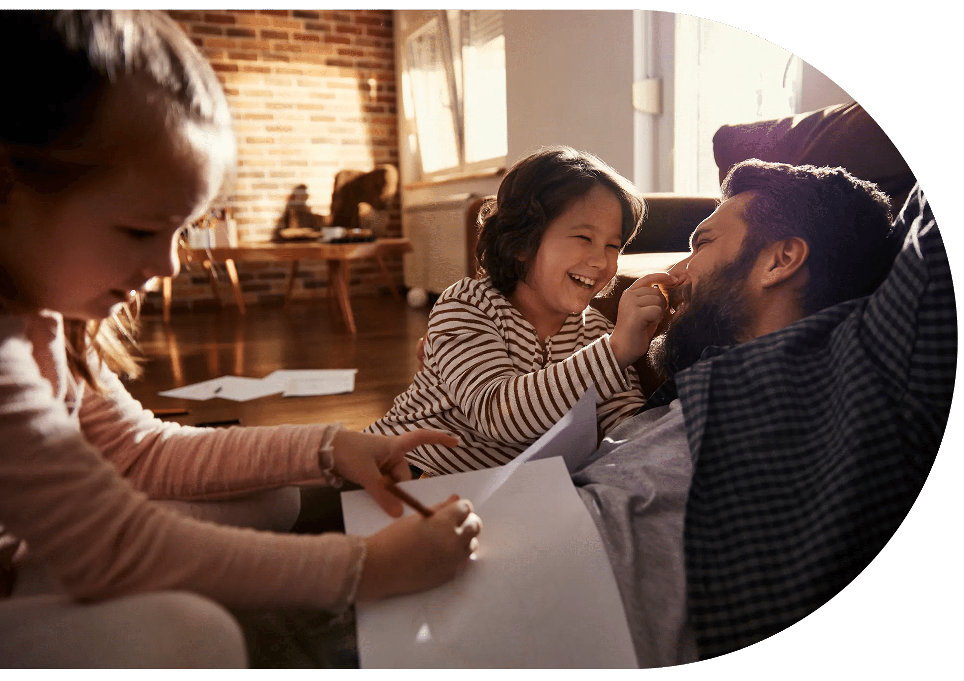 A father and his two children playing and drawing