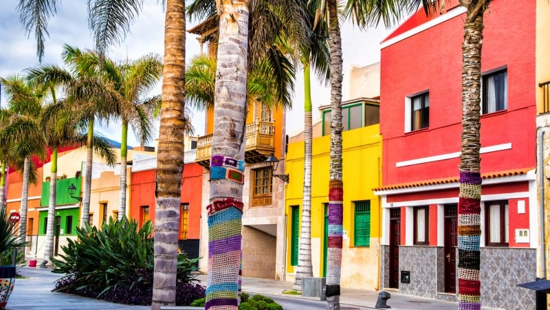 Colourful houses and palm trees on street in Puerto de la Cruz town, Tenerife