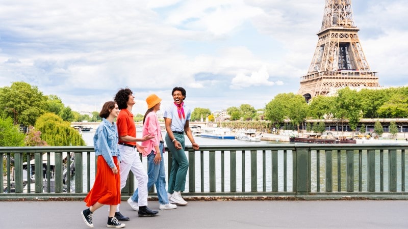Group of friends walking in Paris with the Eiffel Tower in the background