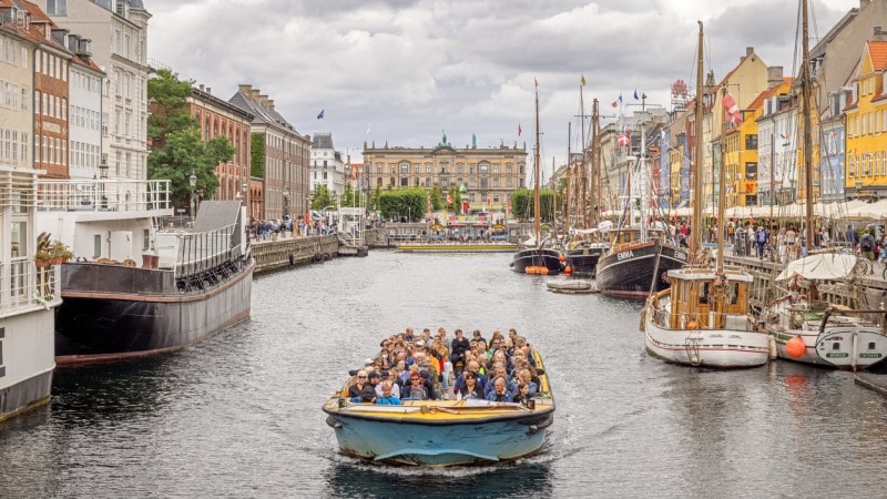 Sightseeing boat sailing through New Harbor in Copenhagen