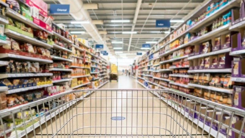 Supermarket trolley facing an isle in the background