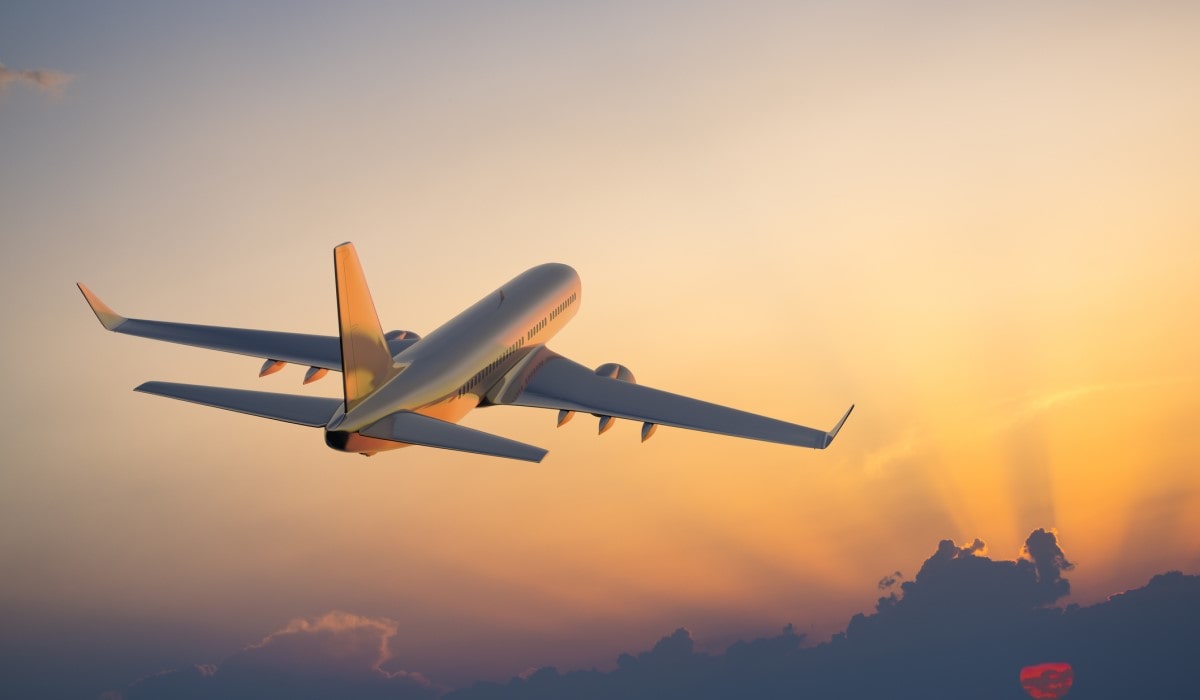 Plane taking off at sunset